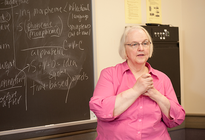 Professor teaching in front of a chalkboard